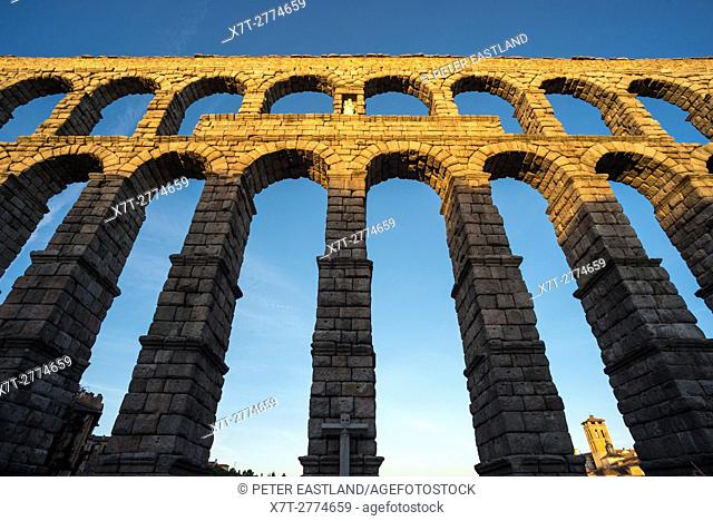 Late evening sunlite on Segovia's 1st century Roman Aqueduct in the Plaza Azuguejo, Segovia, Spain