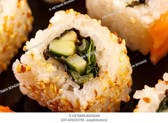 Roll the delicious sushi on a black background