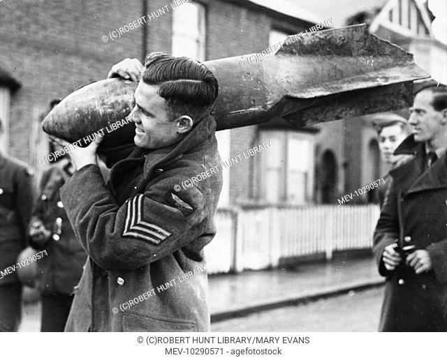 Volunteer carrying away an unexploded bomb, which fell in Bromley, Kent - one of a payload of twenty two bombs