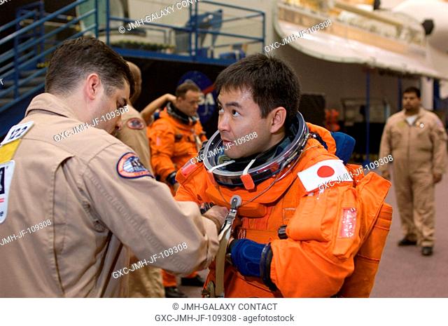Japan Aerospace Exploration Agency (JAXA) astronaut Akihiko Hoshide, STS-124 mission specialist, dons a training version of his shuttle launch and entry suit in...