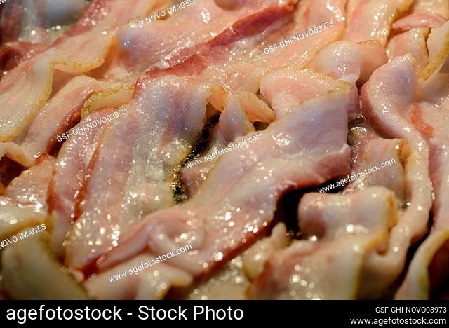 Close-up of Bacon cooking in Skillet