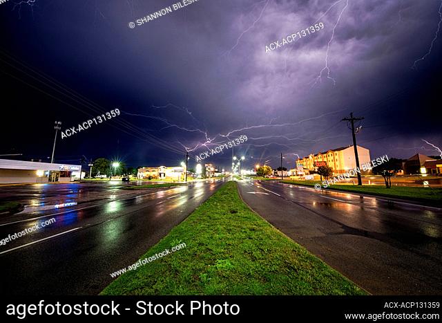 Storm with lightning strikes over city roads in Oklahoma City Oklahoma United States