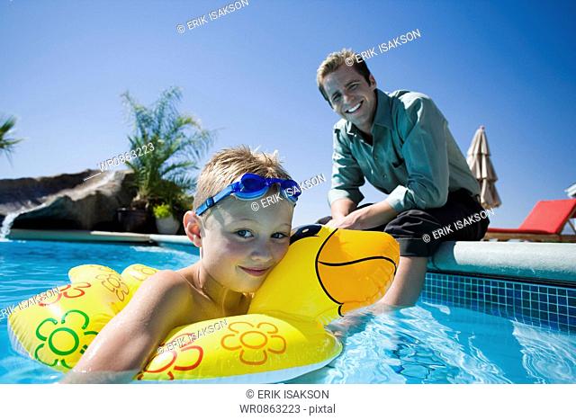 Father and son at swimming pool