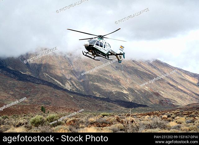 01 December 2023, Spain, La Orotava: A helicopter of the Spanish Guardia Civil police unit lands near the Roques de Garcia in the national park on Mount Teide