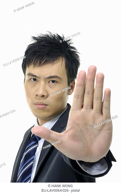 Businessman showing stop sign