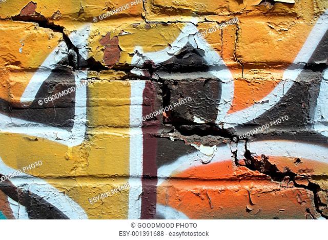 Bright graffiti on a cracked brick wall