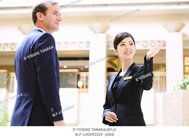 Japanese female hotel concierge dealing with a customer