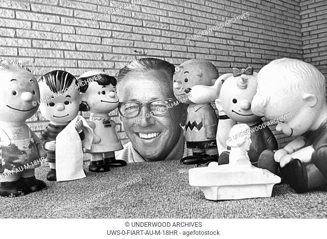 California: October, 1966 Cartoonist Charles Schultz is seen here surrounded by rubber doll replicas of the characters in his ""Peanuts"" comic strip