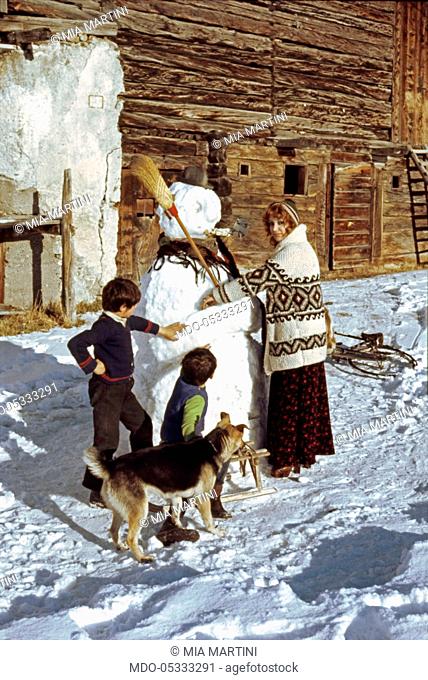 The singer Mia Martini (Domenica Rita Adriana Bertè) making a snowman. Livigno, Italy. 1973