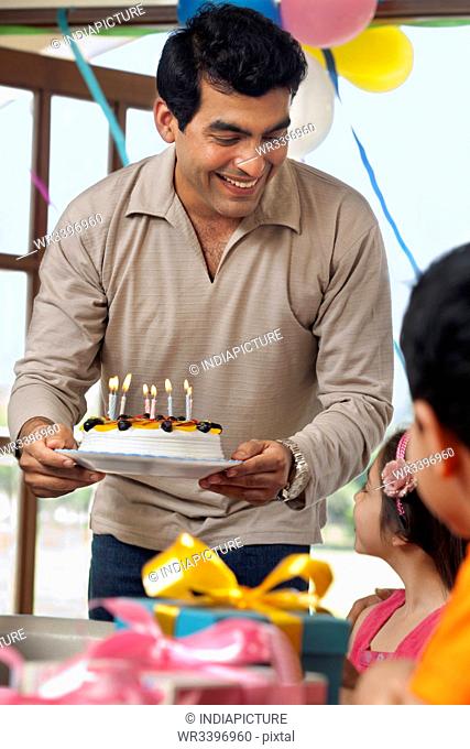 Man holding a birthday cake