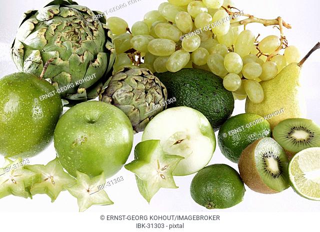 Assorted green fruit on white ground