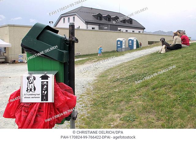 Picture of a dog toliet, bags for dog droppings and a trash can, taken in Muottas Muragl - a good 2500 meters high - in the canton of Graubunden, Switzerland