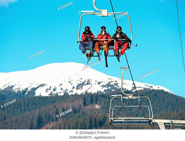 BUKOVEL, UKRAINE - DEC 08, 2015: Skiers on a ski lift in Bukovel. Bukovel is the most famous ski resort in Ukraine