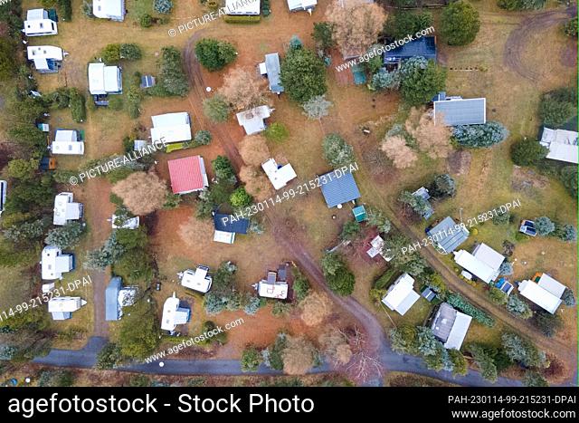 PRODUCTION - 12 January 2023, Saxony, Altenberg: Motorhomes parked at the Galgenteich campsite. (Aerial photo taken with a drone) On tour with a motor home:...
