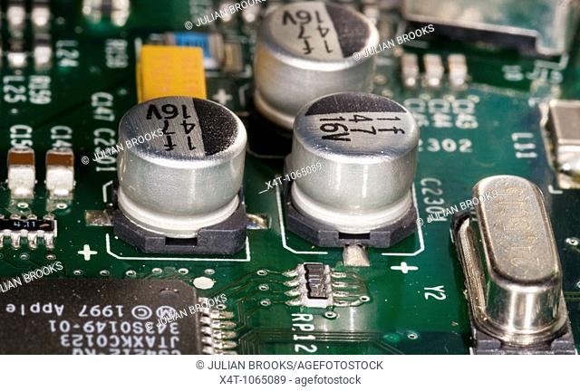 close up photograph of electronic components on a computer mother board showing surface mount technology