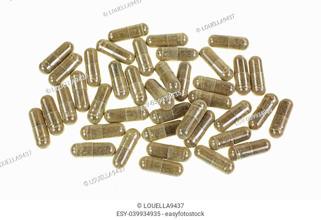 Looking down at a group of green tea capsules on white