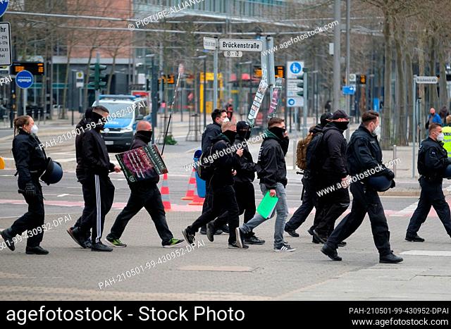 01 May 2021, Saxony, Chemnitz: Supporters of the far-right party ""Der III. Weg"" are escorted by the police to a rally of the party ""Free Saxony""