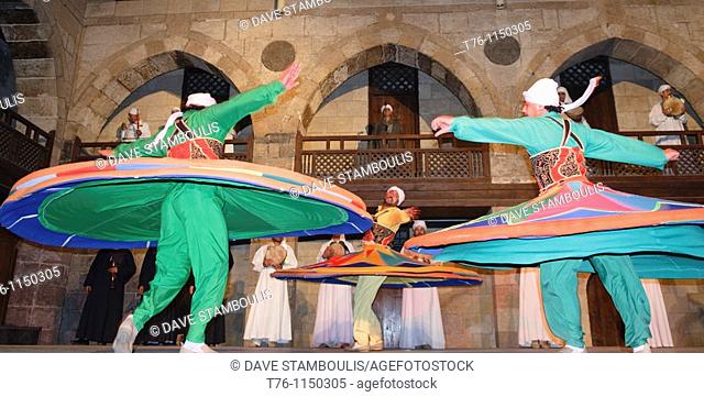 whirling dervish Sufi dancers in motion at performace in Cairo Egypt