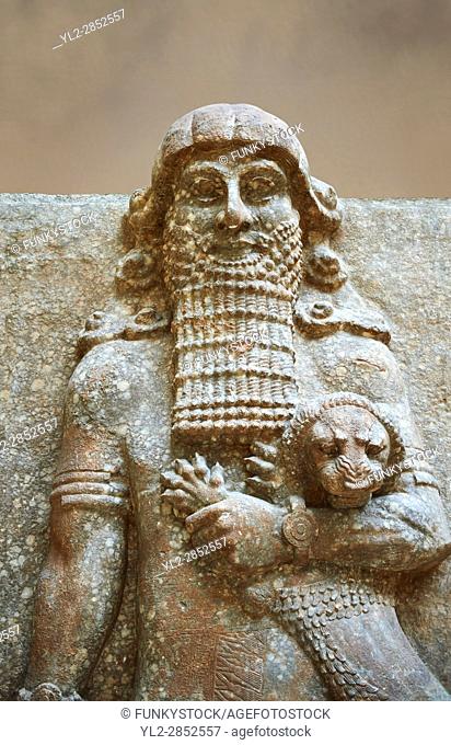 Stone statue of a Hero holding a lion. From facade M of the palace courtyard , Inv AO 19861 from Dur Sharrukin the palace of Assyrian king Sargon II at...