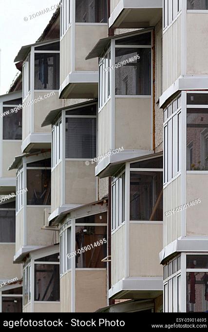 Many of identical balconies on living building, vertical shot