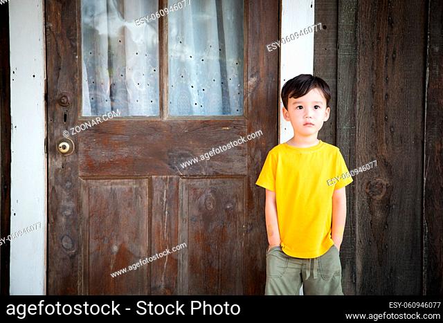 Mixed Race Chinese and Caucasian Boy Standing Alone on Porch