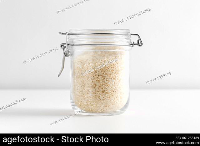 close up of jar with rice on white table