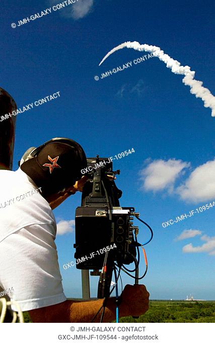 A videographer with NASA's Kennedy Space Center (KSC) captures the launch of Space Shuttle Discovery on its STS-124 mission to the International Space Station...