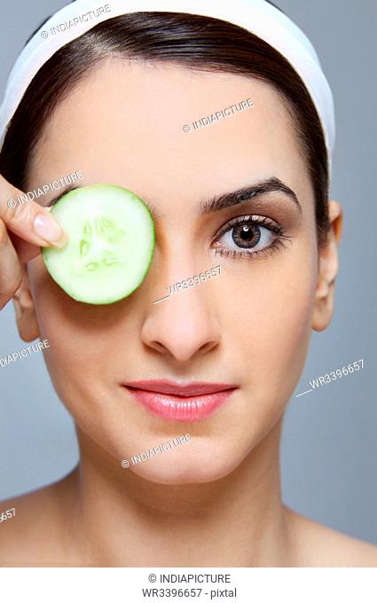 Woman with a cucumber over her eye