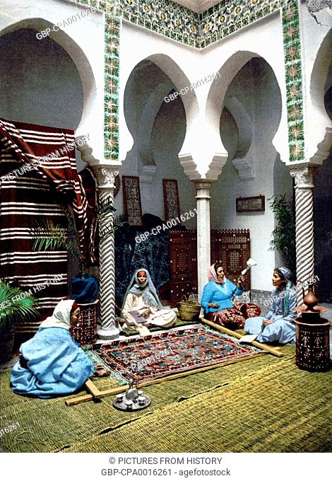 Algeria: Women carpet makers at work in an Algiers courtyard, 1899 (early photograph)