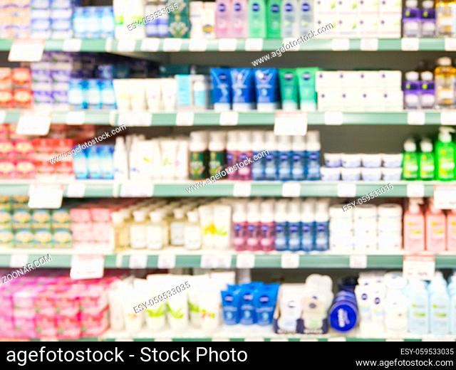 Abstract blurred supermarket shelf with colorful cosmetic goods as background