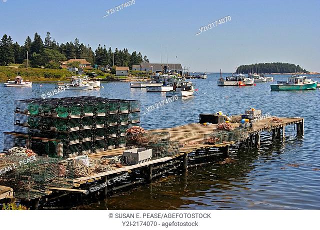 Pier stacked with lobster traps in the harbor of the fishing village of Gouldsboro, Maine, United States