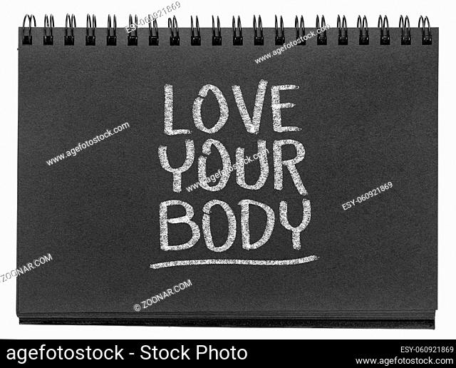 love your body - white chalk inspirational text in a black paper spiral sketchbook, self esteem, acceptance and self care concept