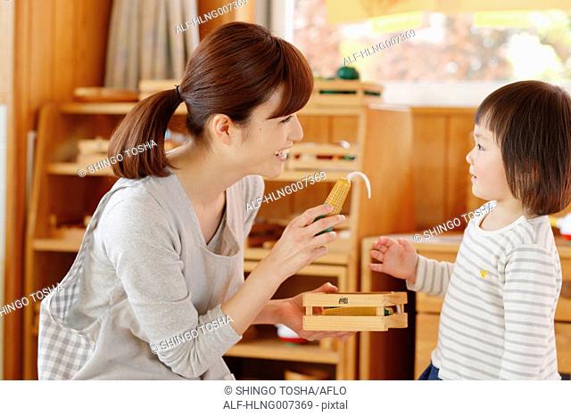 Teacher with kid at Japanese kindergarten