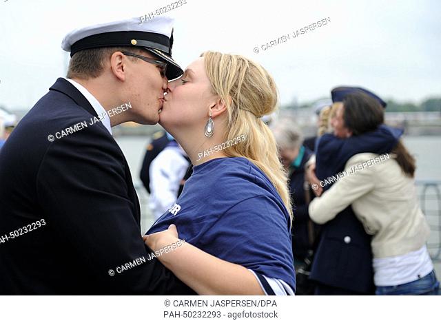 A crew member of the frigate Augsburg kisses his partner on the deck of the frigate after the frigate's return to the naval base in Wilhelmshaven, Germany