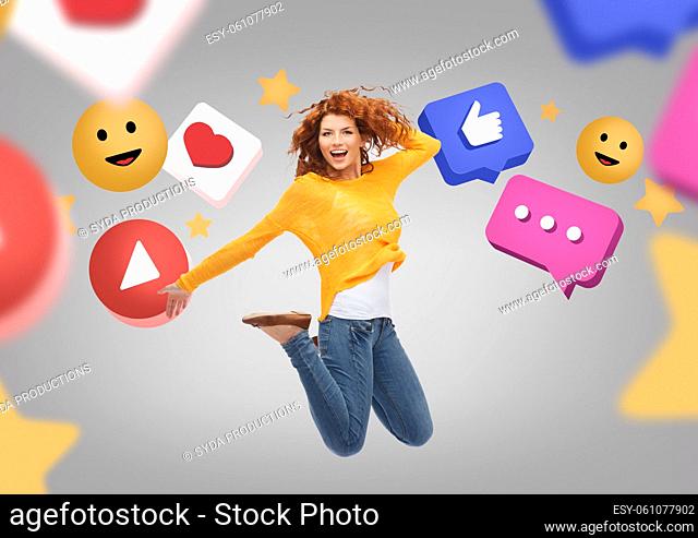 smiling young woman jumping over internet icons