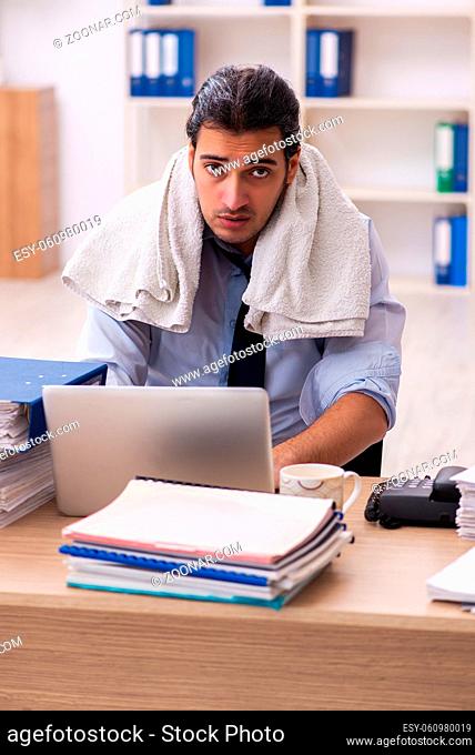 Young businessman employee sweating in the office