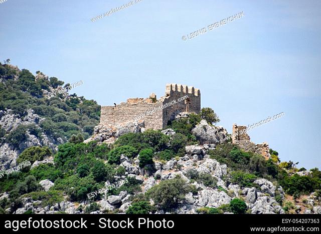 The ruins of an ancient fortress on top of a cliff. Kekova Turkey city ruins