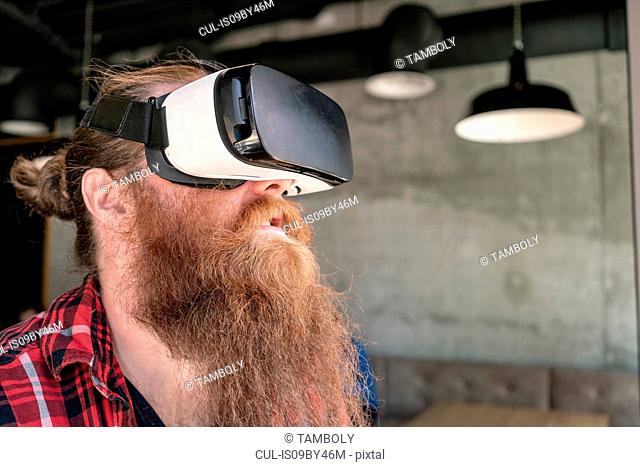 Male hipster using VR goggles