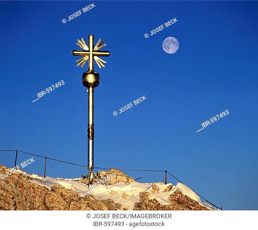 Full moon and summit cross at 2962 m or 9718 ft on the Zugspitze, Germany's highest mountain, Wetterstein Range, Werdenfels Region, Upper Bavaria, Bavaria