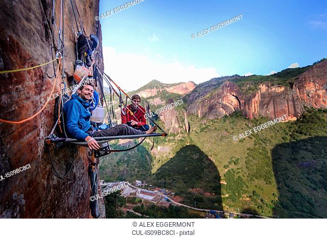 Portrait of two rock climbers on portaledge, Liming, Yunnan Province, China