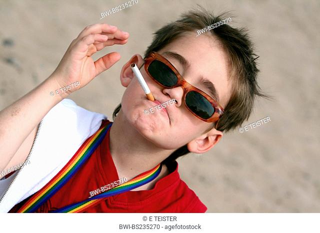 10 years old cool boy with sunglasses and cigarette