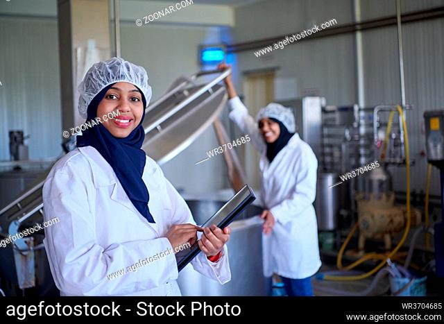 middle eastern black african muslim female business woman team in local cow and goat milk cheese food production company