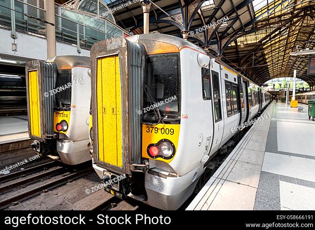 London, United Kingdom - May 14, 2019: Stansted Express Train on the platform at Victoria railway Station, Modern Commuter Train inside the Victoria Railway...