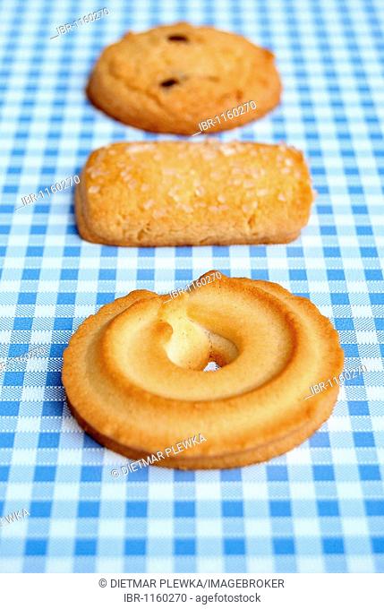 Danish butter cookies with or without sugar, pretzels, on checked tablecloth