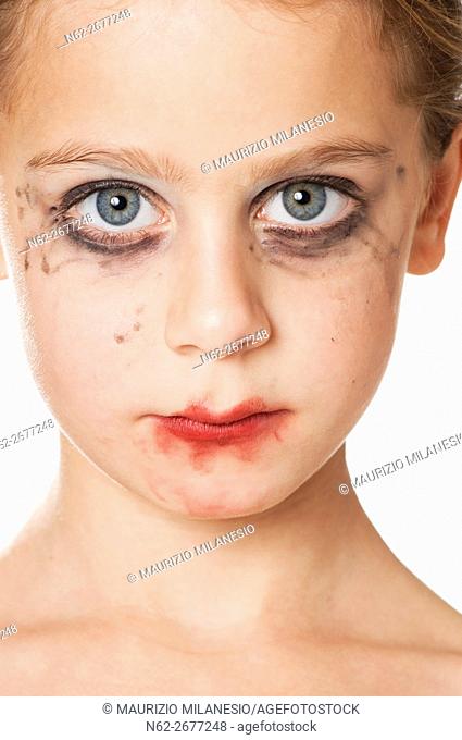Front view of a little girl with smeared makeup on her face