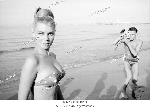 A pretty girl photographed on a beach during the XVIII Venice International Film Festival. Venice, 1957