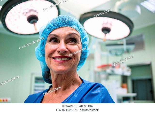 Smiling surgeon standing in operation room