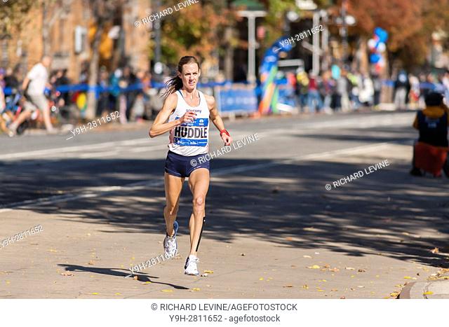 American Molly Huddle passes through Harlem in New York near the 22 mile mark near Mount Morris Park on Sunday, November 6