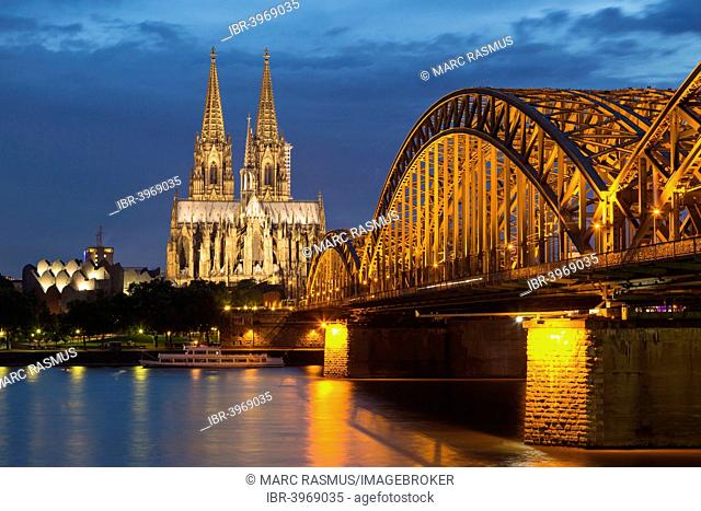 Cologne Cathedral with Hohenzollern Bridge and Cologne Philharmonic Hall at dusk, the Rhine at the front, Cologne, North Rhine-Westphalia, Germany