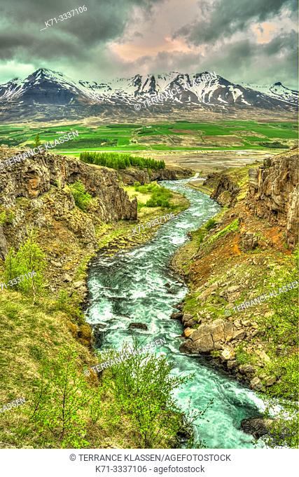A scenic landscape view of mountains and a stream near Akureyri, Iceland, Europe